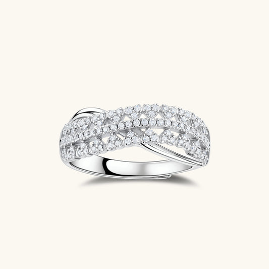 Sterling silver crossover ring with pavé-set moissanite stones creating an elegant infinity design on neutral background